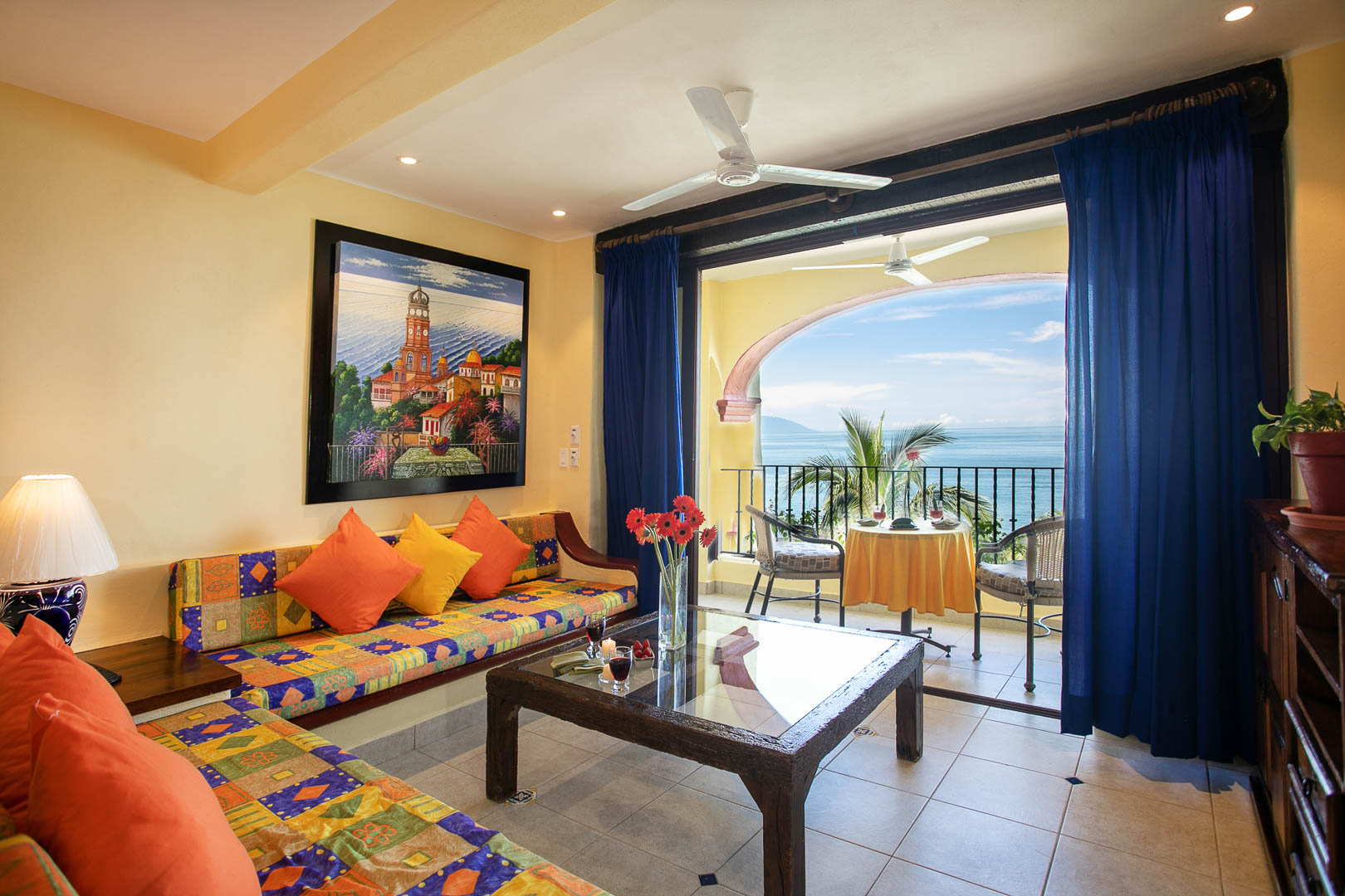 A vibrant living room with a view that oversees the ocean at TPI's Lindo Mar Resort in Puerto Vallarta, Mexico.